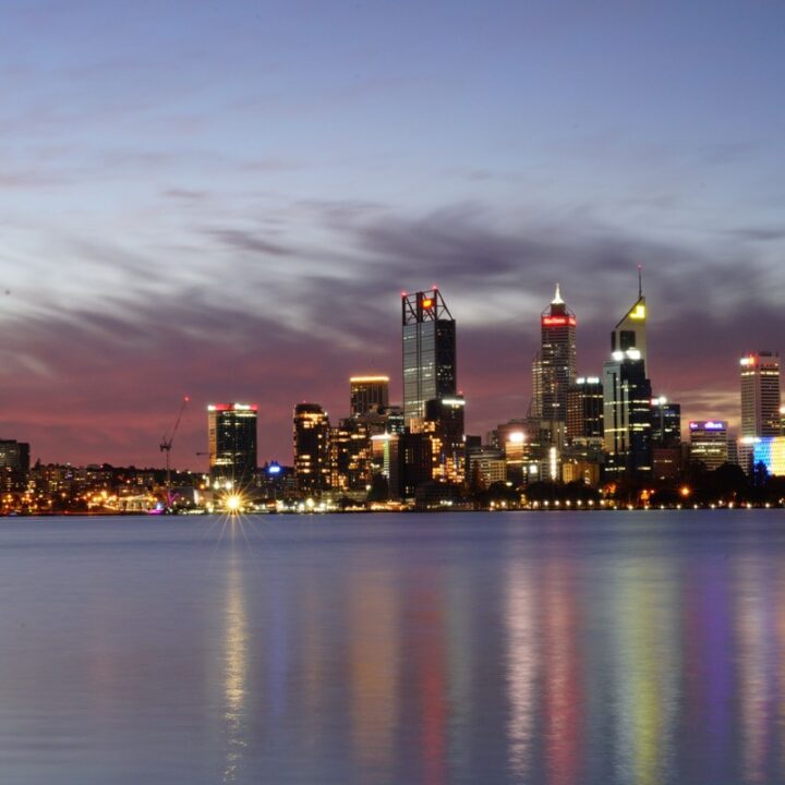 Perth city skyline reflected on the water at dusk
