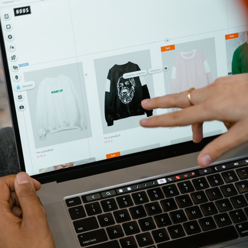 Hands testing an online shop layout on a laptop