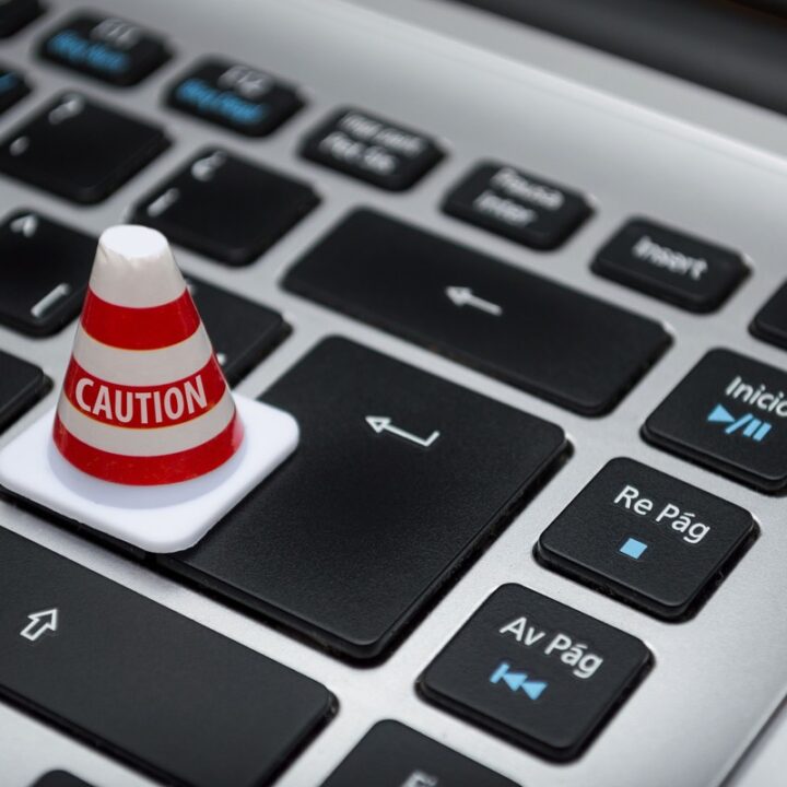 Caution cone placed on a computer keyboard