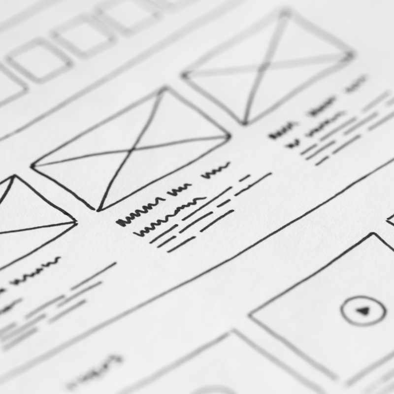 Hand-drawn wireframe design on paper for a user experience project