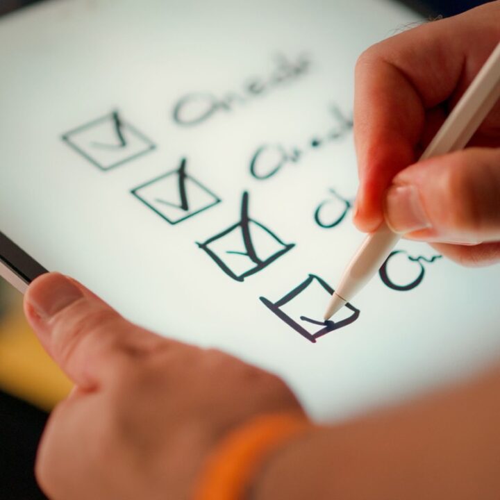 Digital checklist displayed on a tablet beside a stylus