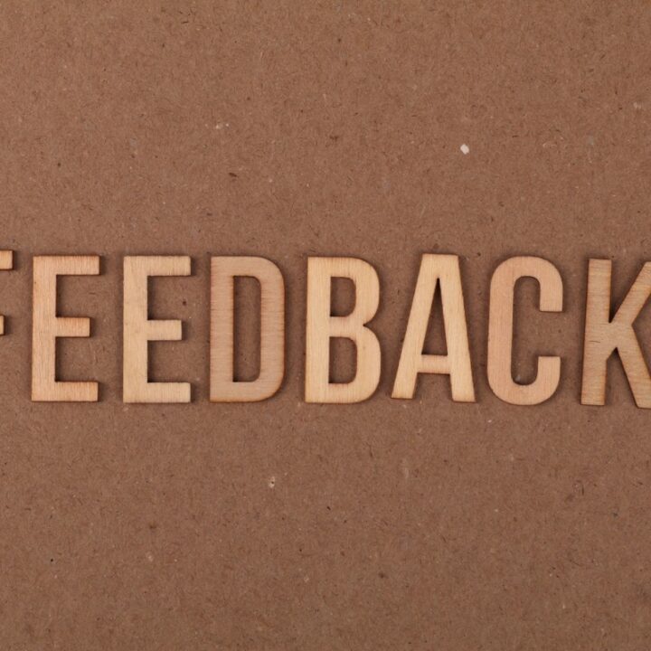 Wooden letters spelling feedback on a textured background