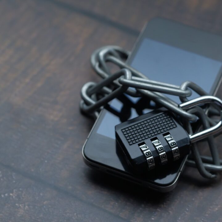 Smartphone secured with a chain and combination padlock