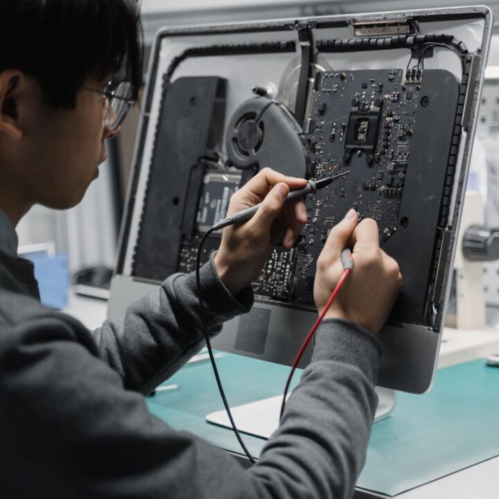 Technician testing an opened computer