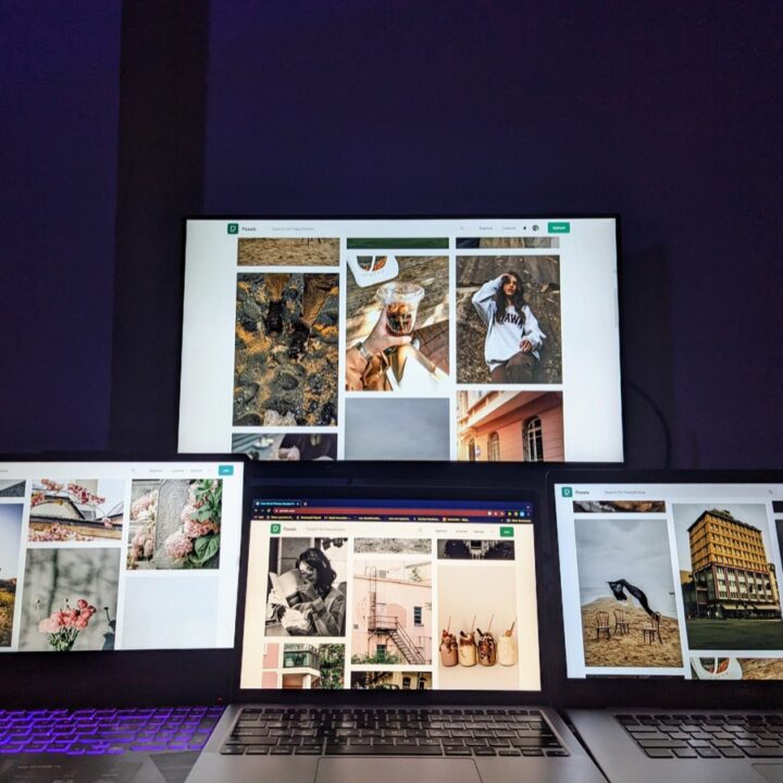 Multiple laptops and a monitor in a technology workspace