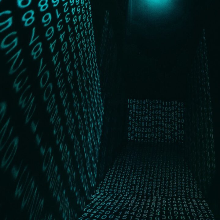 Neon digital number projections in a dark hallway