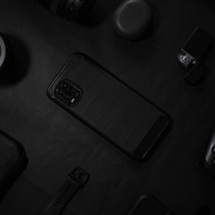 Smartphones and devices on a dark desk