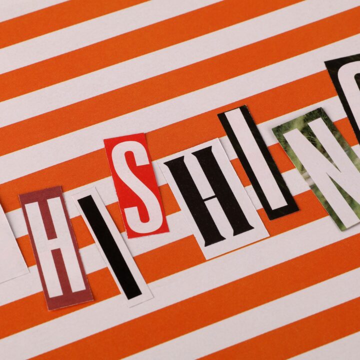 Phishing headline made from cut-out letters on an orange striped background